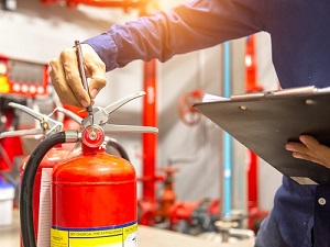 Photo of a officer checking the fire extinguisher