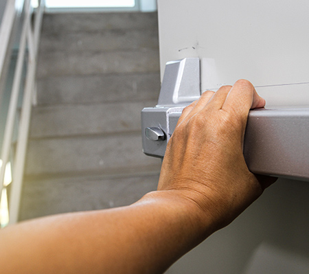 Photo of a Hand Pushing Open Fire Door